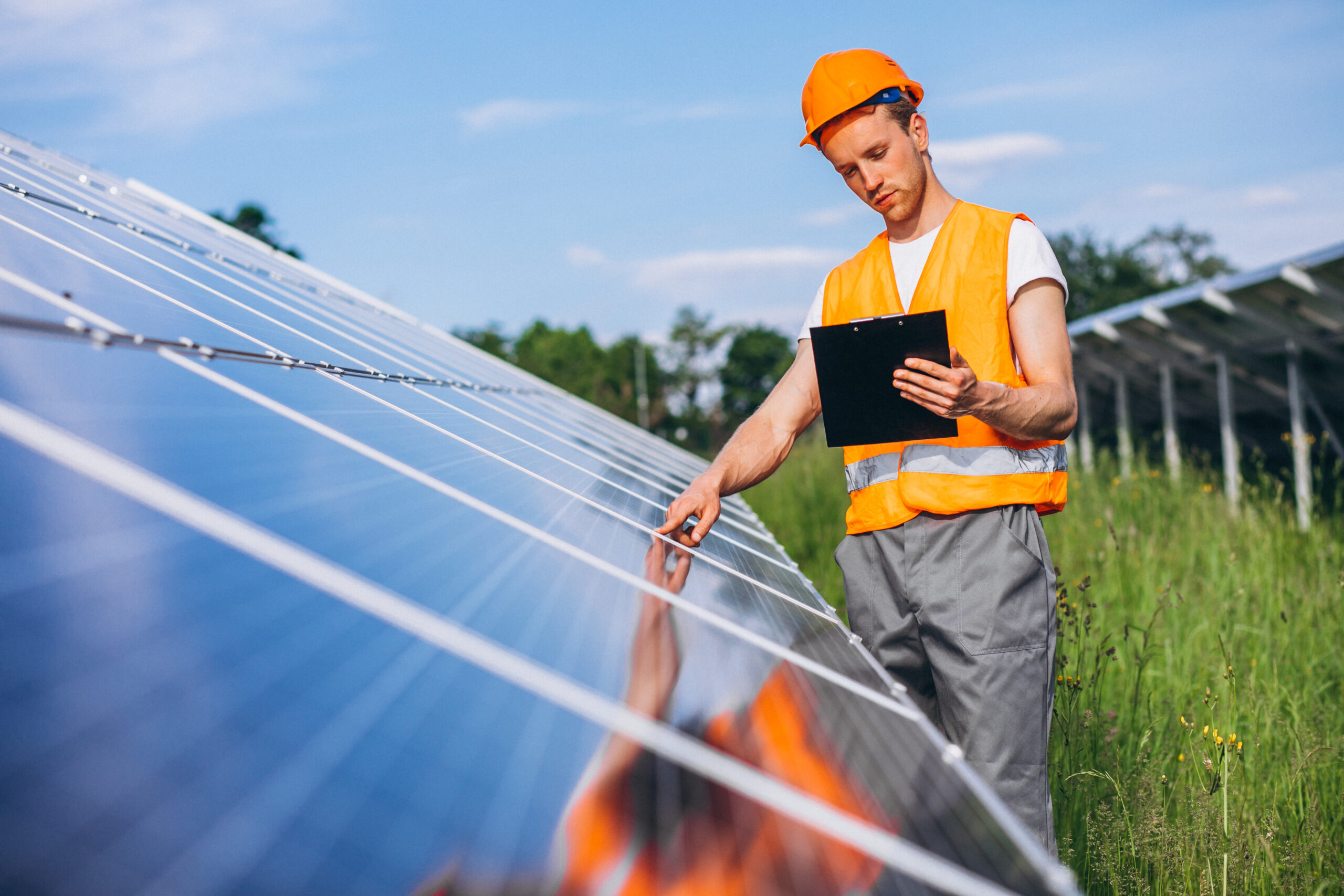 Man worker in the firld by the solar panels